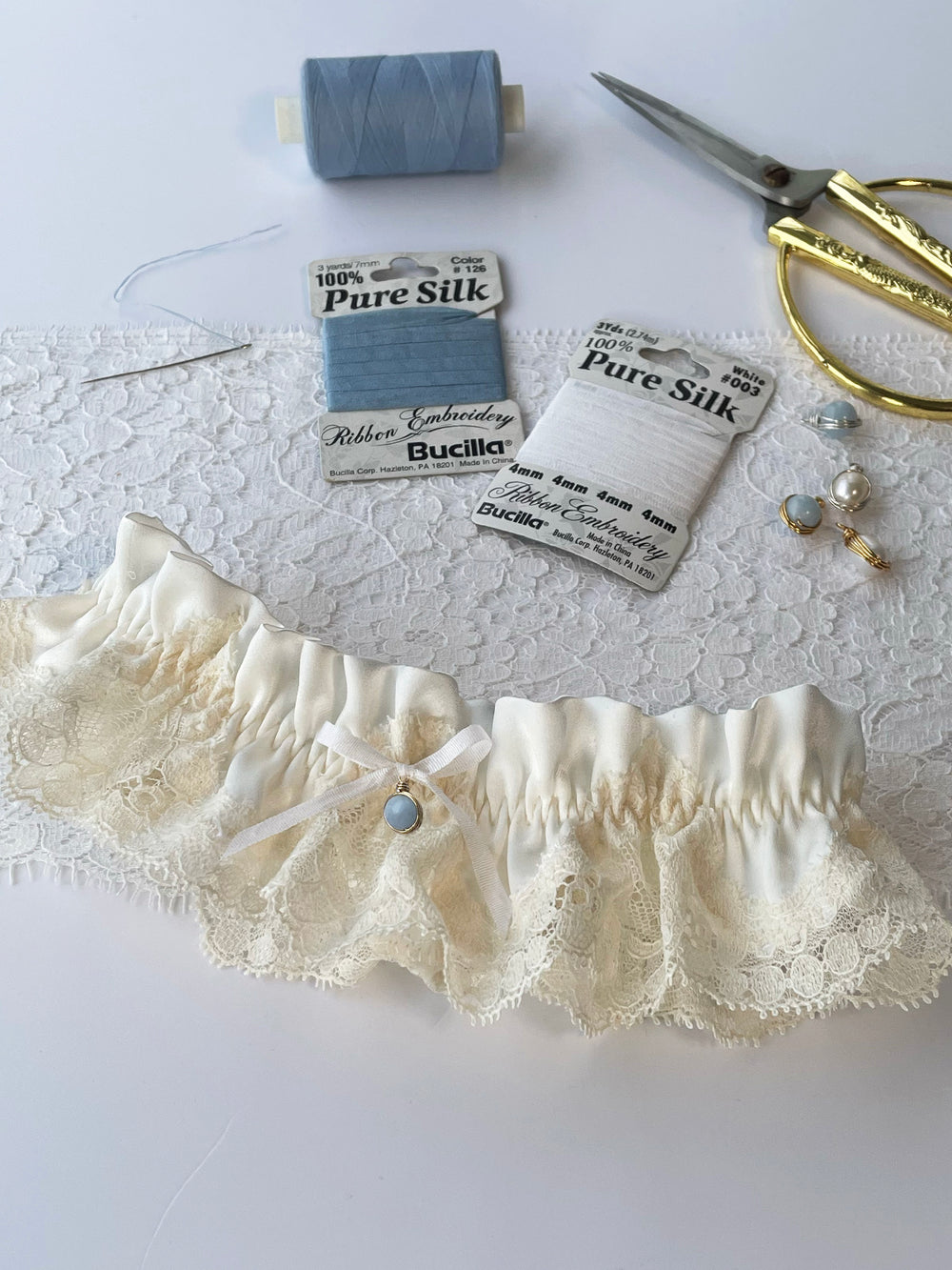 Harper ivory silk garter close-up with white satin bow and lace detail - handmade bridal lingerie Brighton
