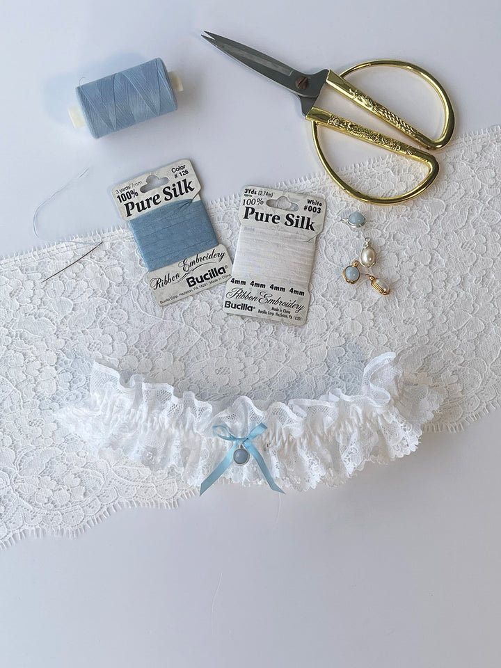 Clara white lace wedding garter with blue satin bow and detachable pendant - something blue bridal tradition
