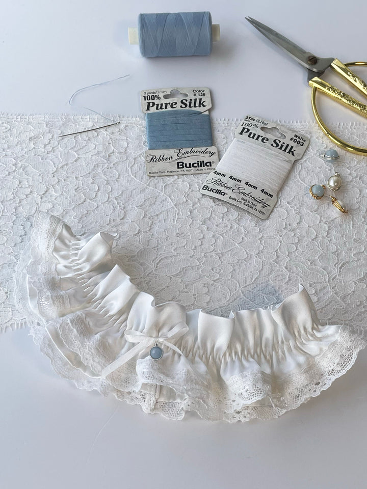 Handmade white silk wedding garter with Oeko-Tex lace and white satin bow - luxury bridal lingerie detail