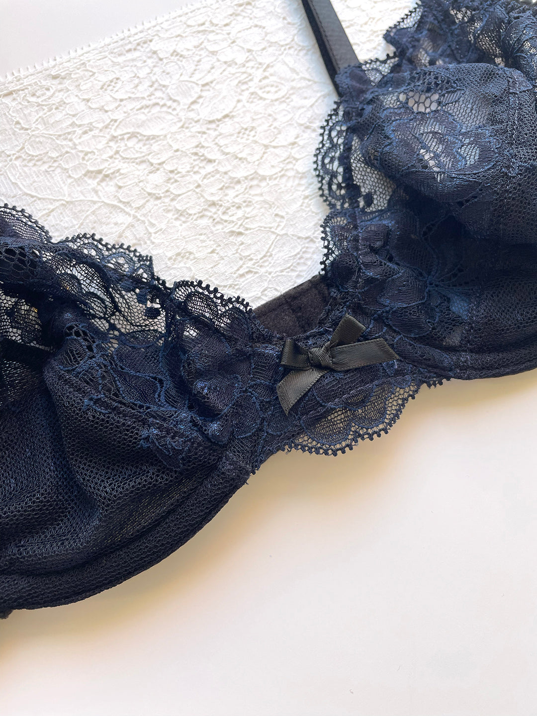 Camilla navy silk plunge bra close-up showing lace cup detail and gold hardware - handmade luxury lingerie Brighton