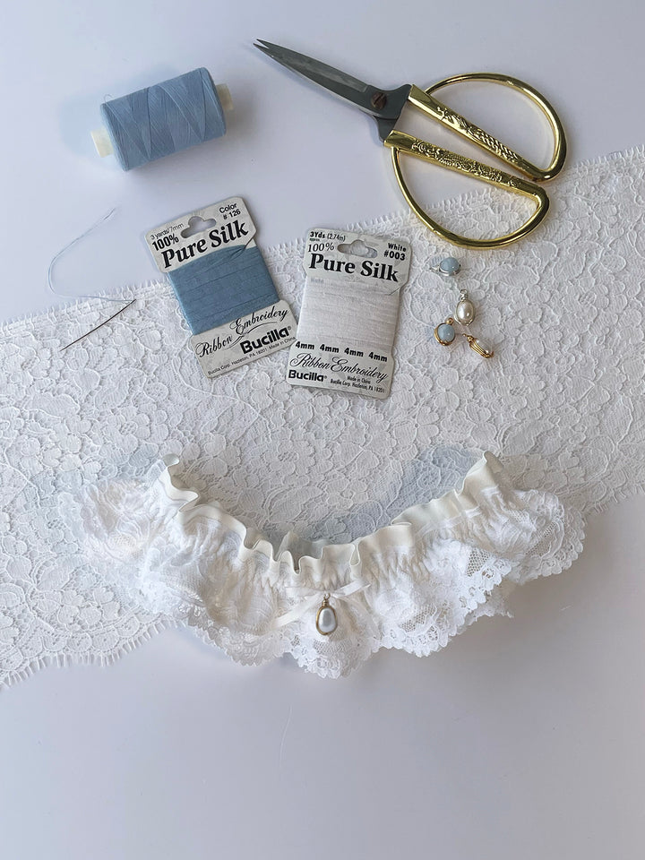 Luxury ivory silk and lace wedding garter with detachable pearl pendant - handmade in Brighton