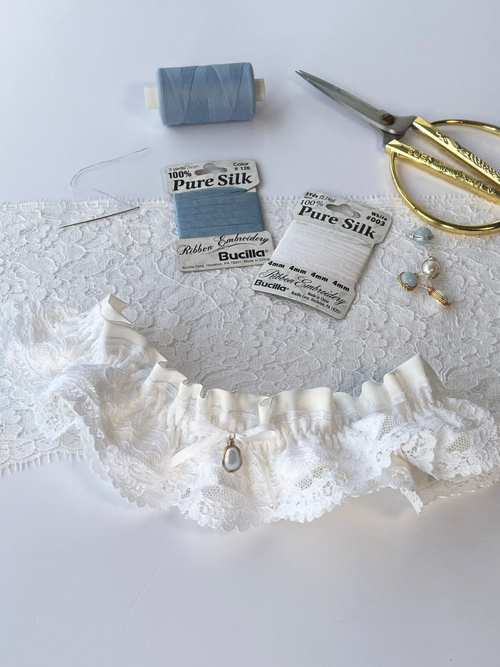 Handmade ivory silk wedding garter with Oeko-Tex lace and white satin bow - luxury bridal lingerie detail