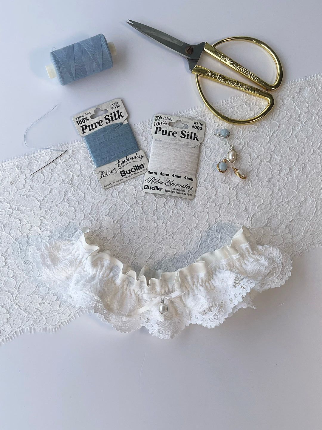 Sophie ivory silk garter with handmade pearl pendant and white satin bow - luxury bridal accessory