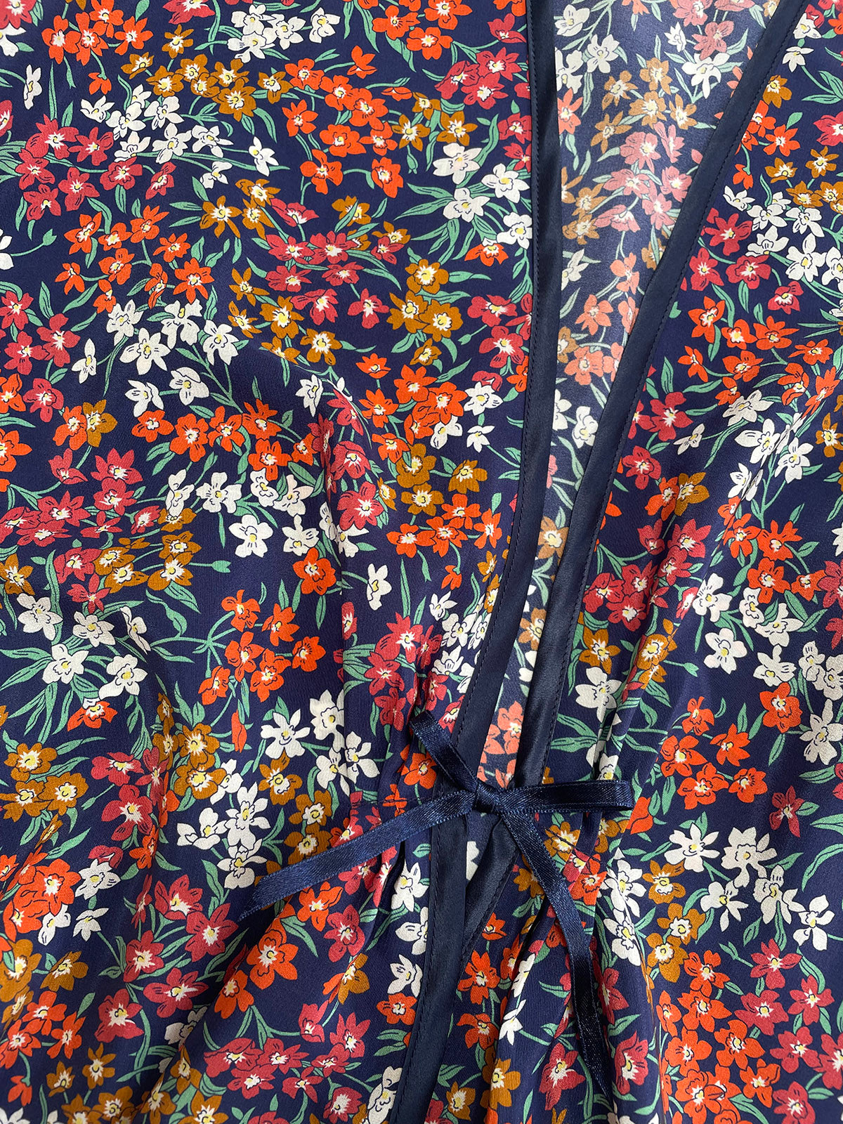 Sea Blossom Liberty Navy Silk Bed Jacket with a tie detail on a dark blue background