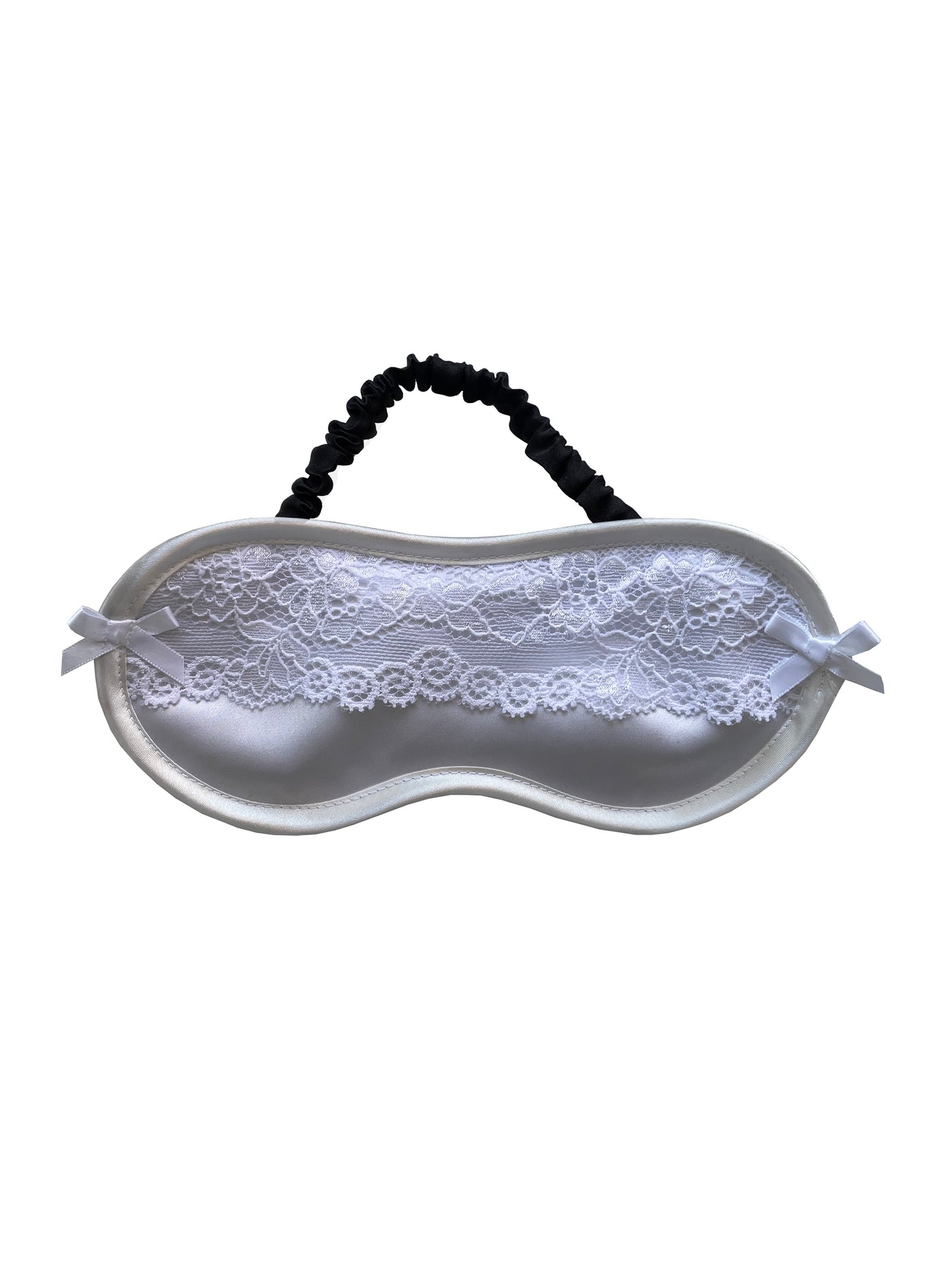 Elegant white silk padded sleep mask with recycled lace trim, adorned with satin bows and designed for a secure fit