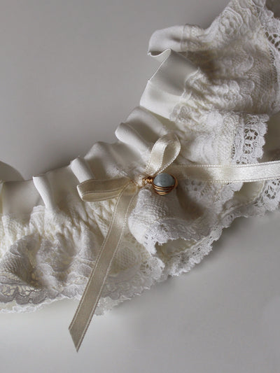 Customizable silk garter with floral lace, gemstone pendant, and hand-tied ribbon bow