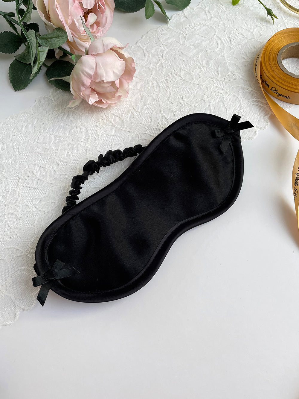 Handcrafted black silk sleep mask with soft padding and adjustable elastic strap - luxury nightwear accessory